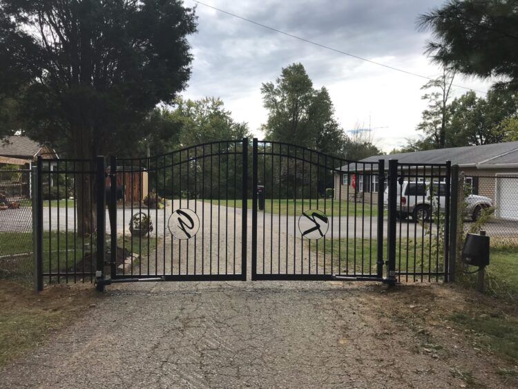 Elegant dual-swing gate with custom initials and automation