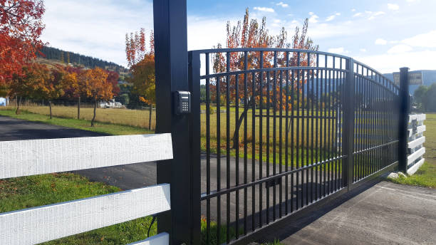 Keypad entry system installed on black automatic driveway gate