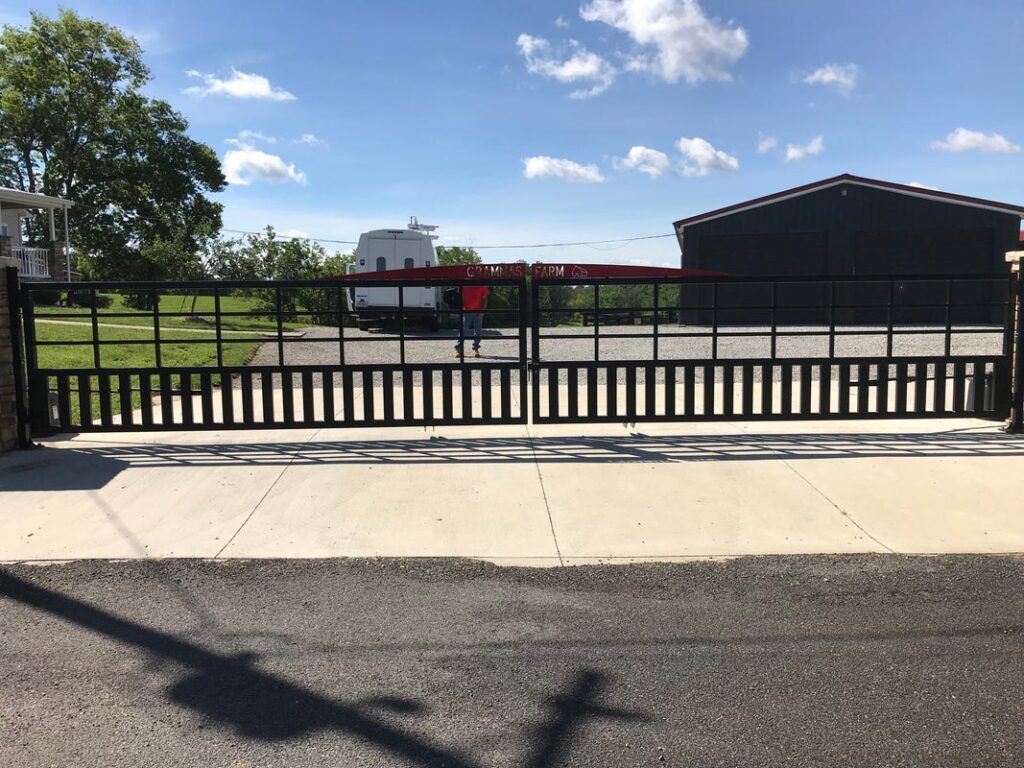 Wide driveway gate fitted with remote-controlled opener system