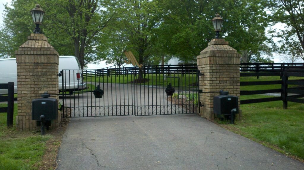 Automatic gate system installed at a private driveway with brick columns