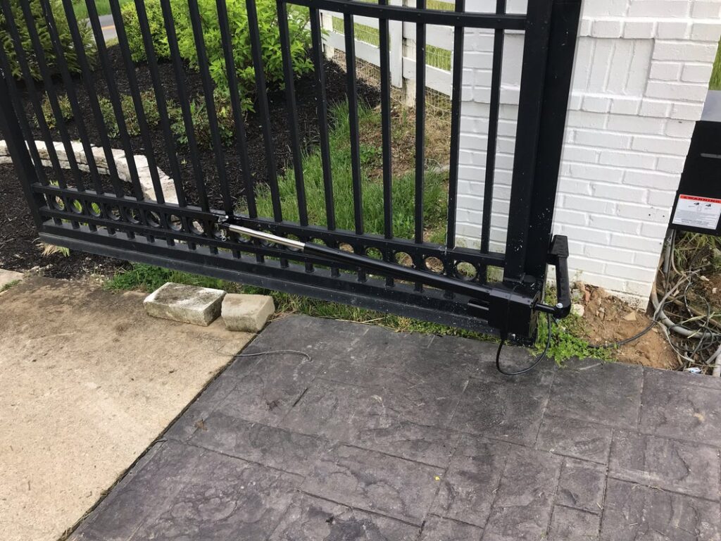 Close-up of automatic swing gate opener installed on metal driveway gate