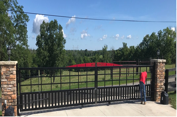Technician installing remote-operated Viking R-6 sliding gate
